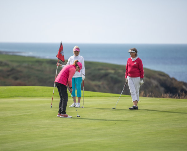 Ladies playing golf